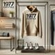 The 1977 Essentials Hoodie displayed on a minimalist setup with neutral tones and stylish accessories.