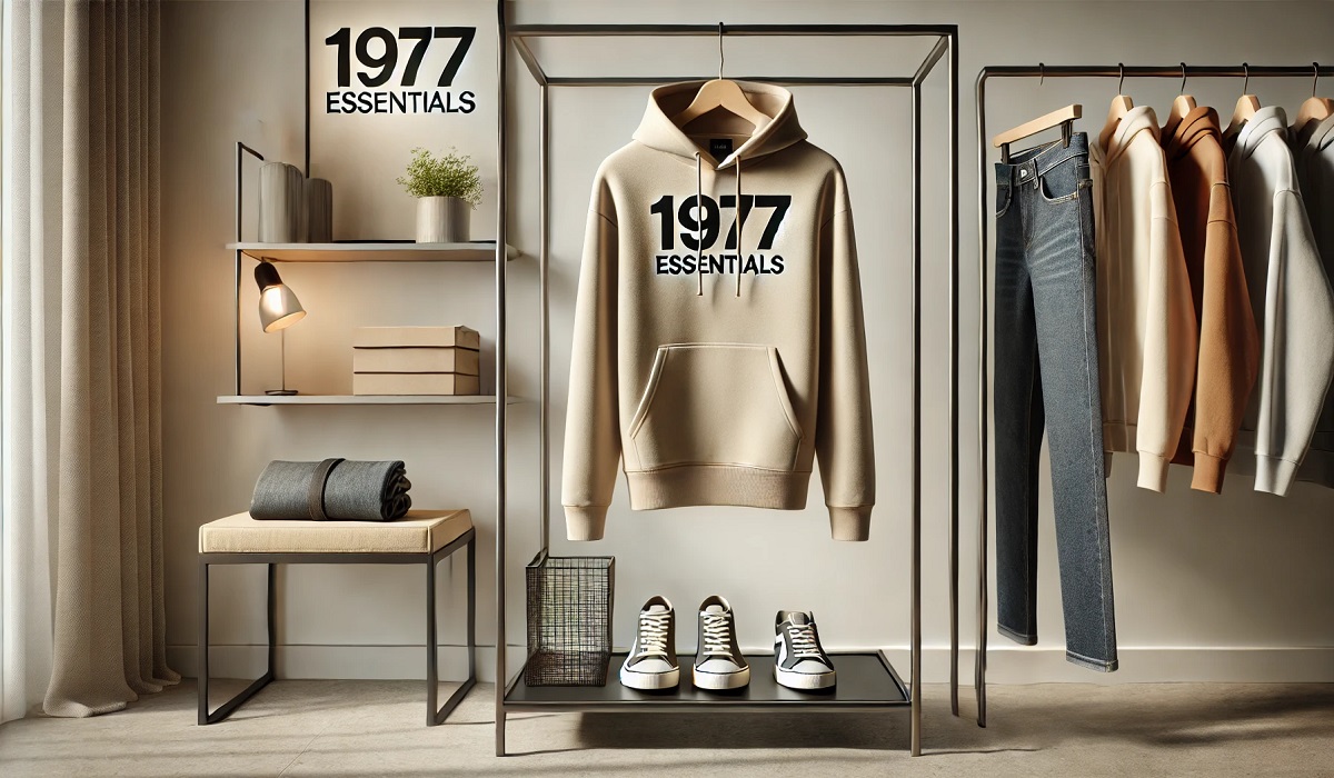 The 1977 Essentials Hoodie displayed on a minimalist setup with neutral tones and stylish accessories.