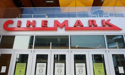 A Cinemark theater exterior with moviegoers entering to watch the latest films.