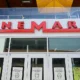 A Cinemark theater exterior with moviegoers entering to watch the latest films.