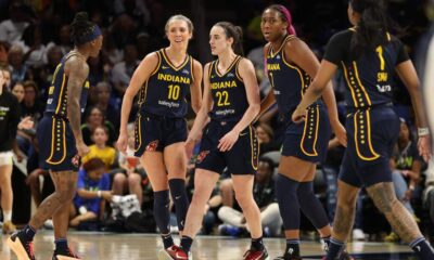 Indiana Fever players on the court during an intense WNBA game.