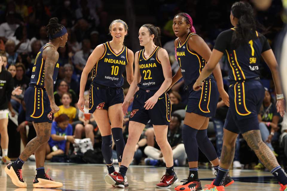 Indiana Fever players on the court during an intense WNBA game.